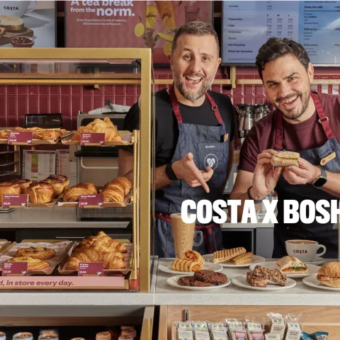 two men in front of of a selection of pastries and coffee with the text COSTA X BOSH! superimposed
