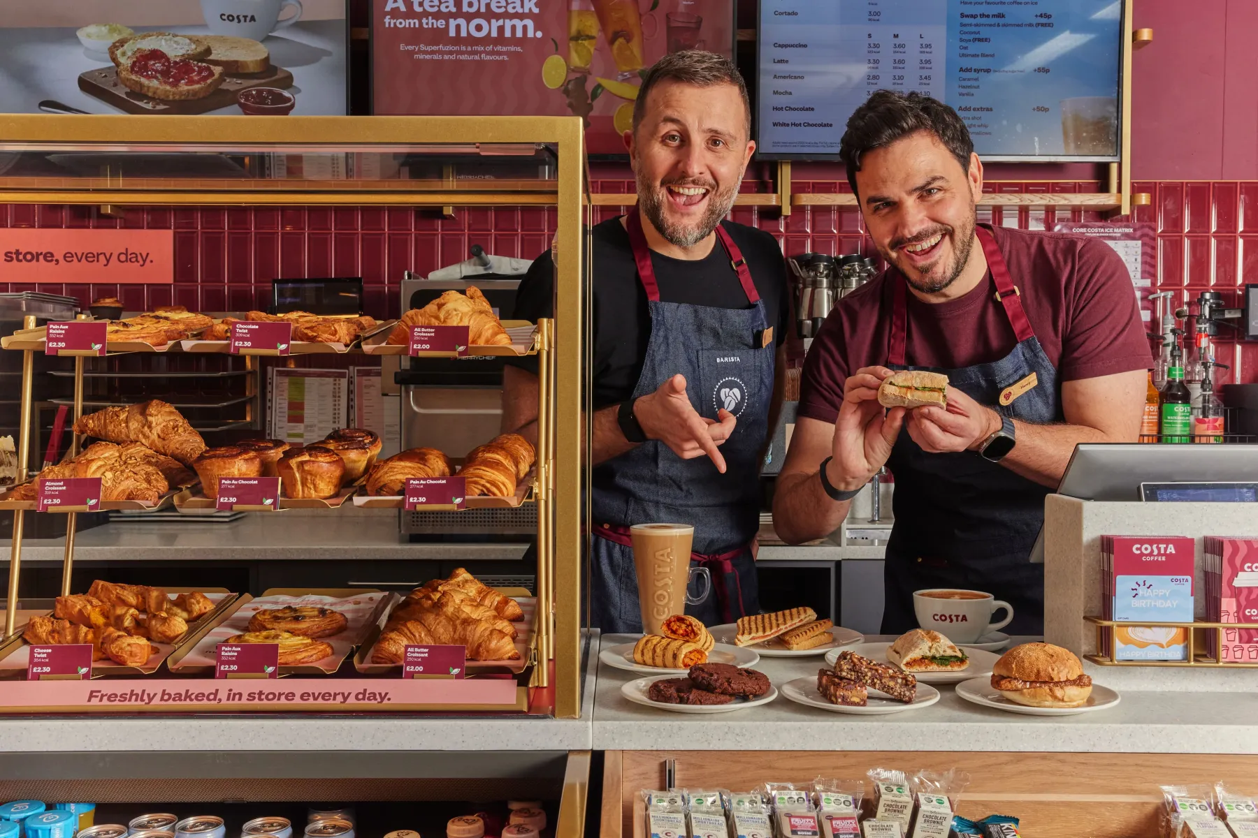 Henry and Ian behind a Costa counter